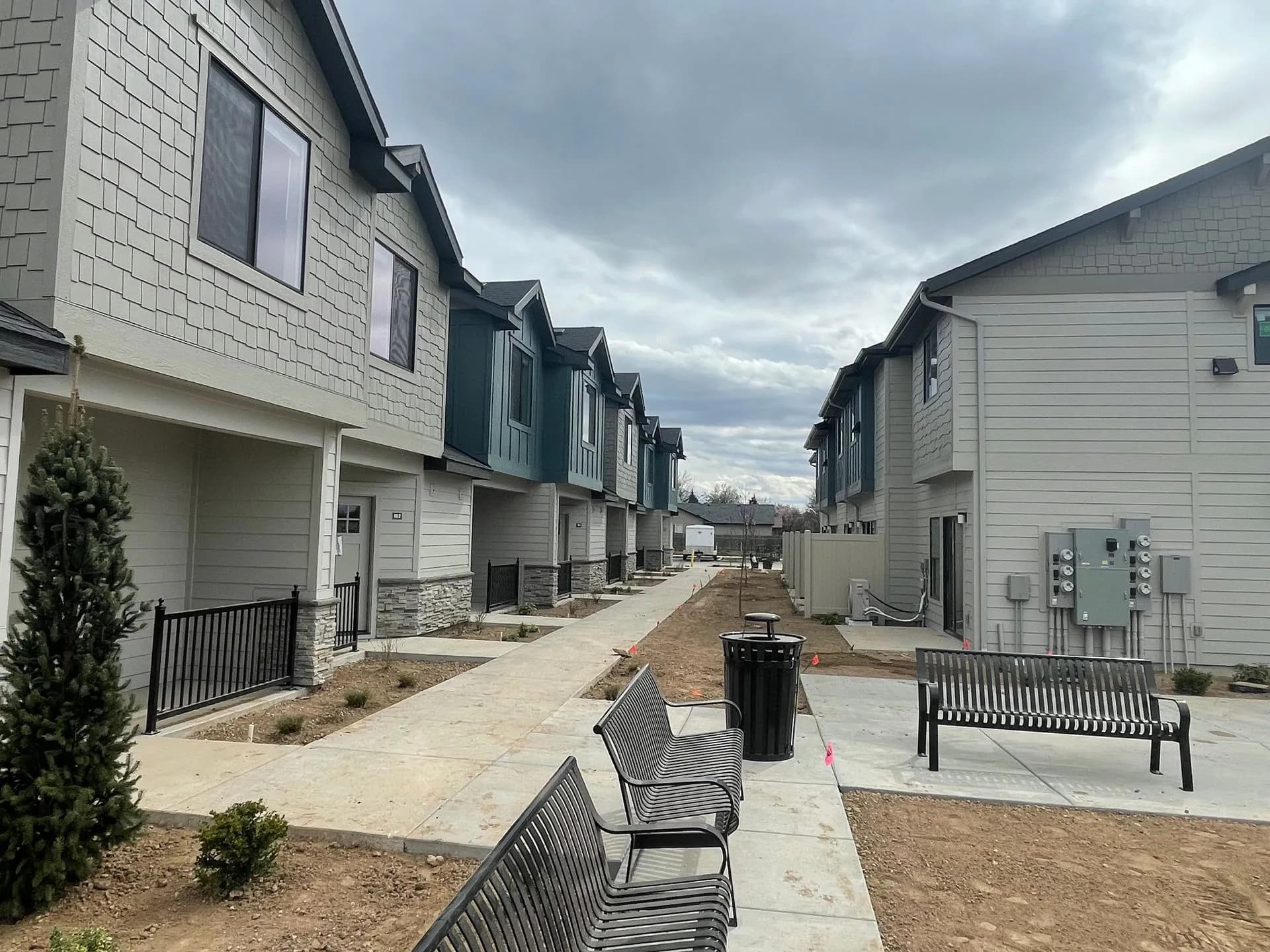 Manicured walkways and landscaping between luxury townhome buildings at Eagle Villa